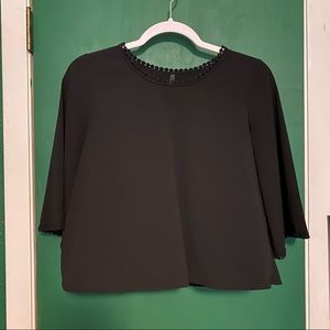 Women’s black crop top with flared sleeves